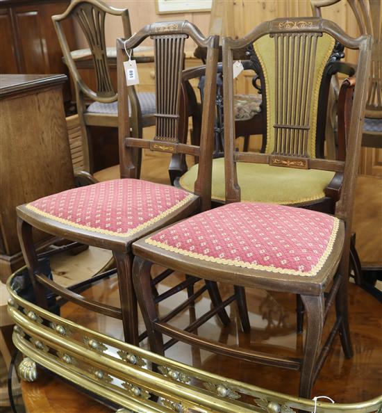 An Edwardian mahogany tub shaped armchair and a pair of inlaid bedroom drawers